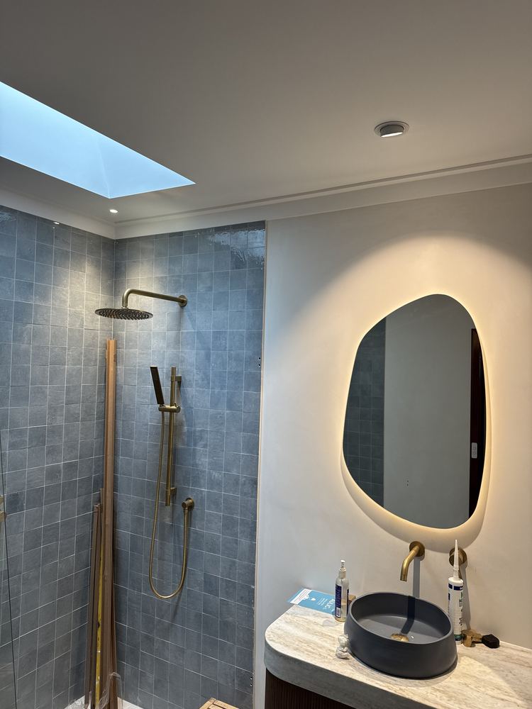 Bathroom renovation with LED mirror and downlights