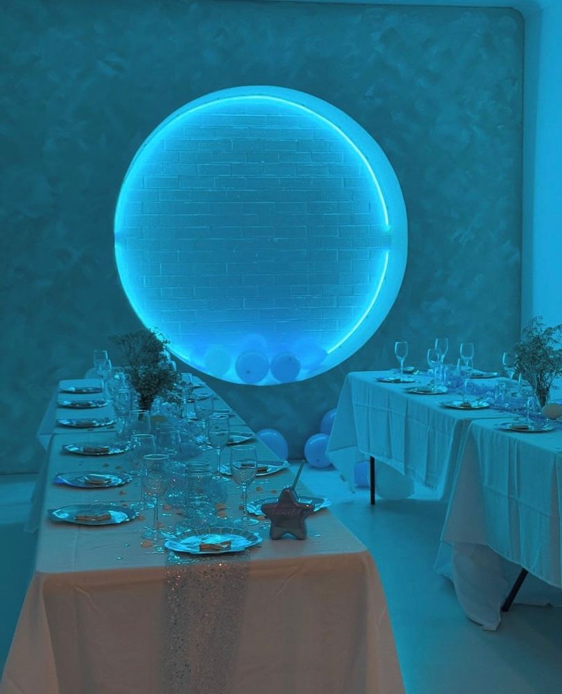 Custom circular LED feature light at an event venue
